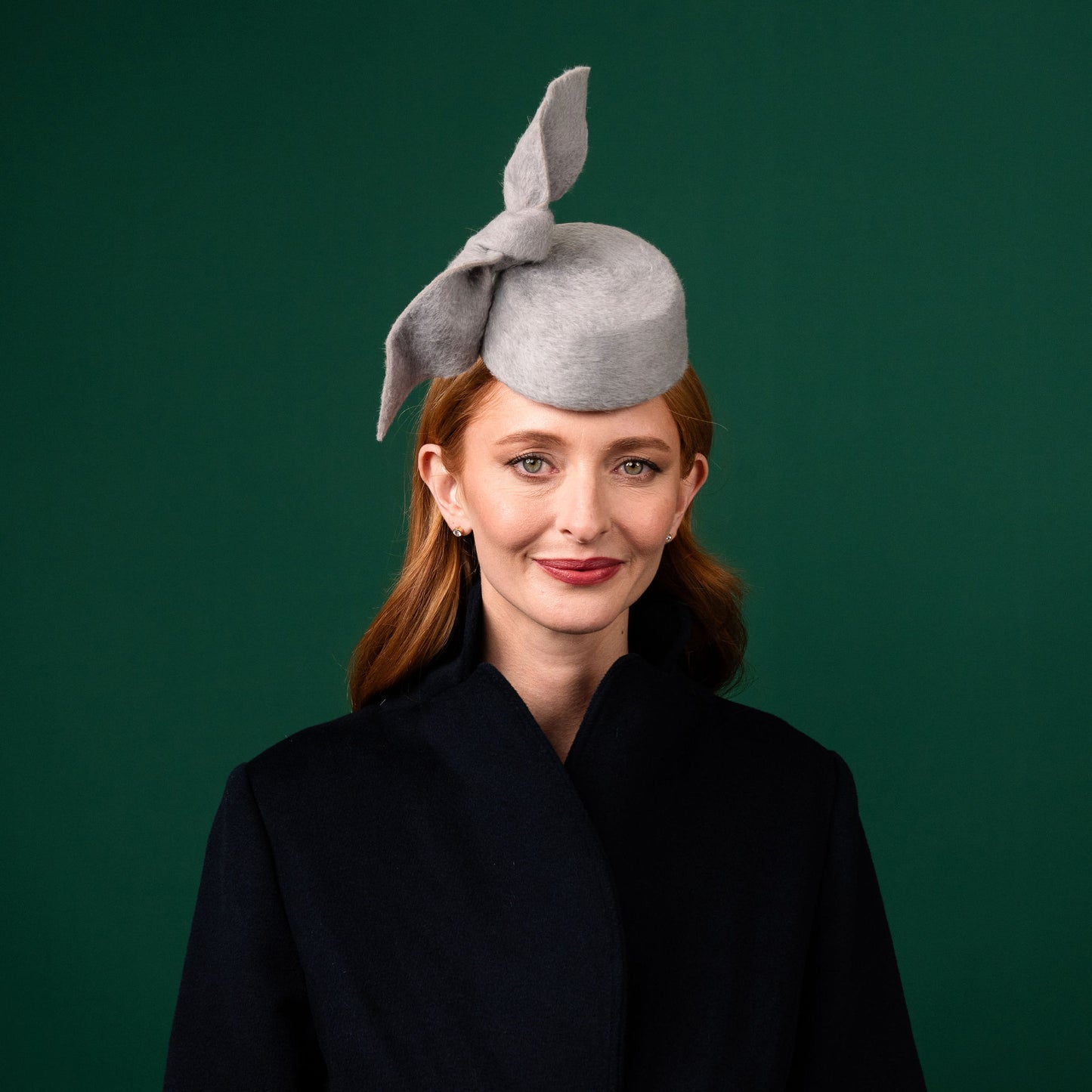 Cresta mini grey felt front of head pillbox with a felt knot trim Winter Racewear Headpiece