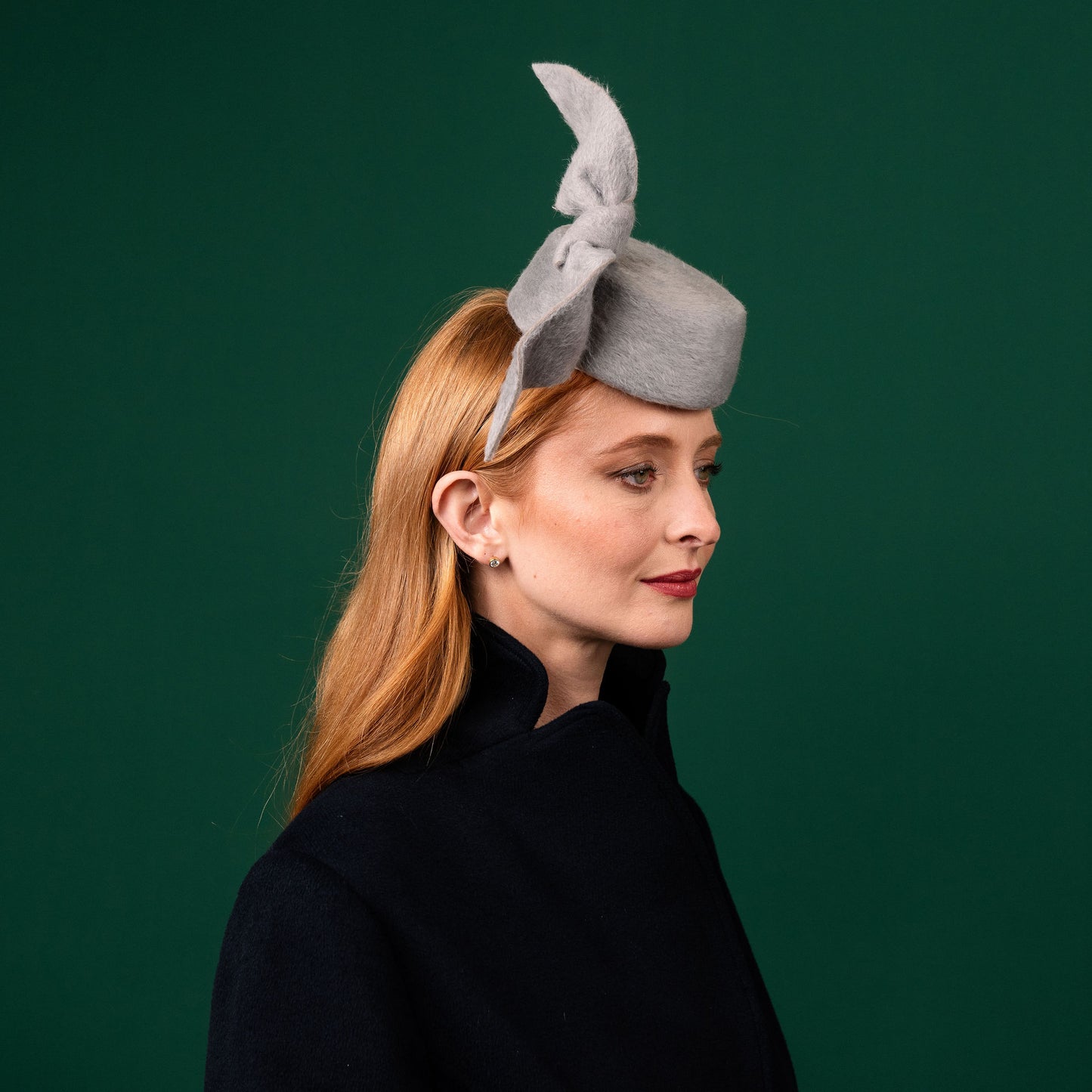 Cresta mini grey felt front of head pillbox with a felt knot trim Winter Racewear Headpiece