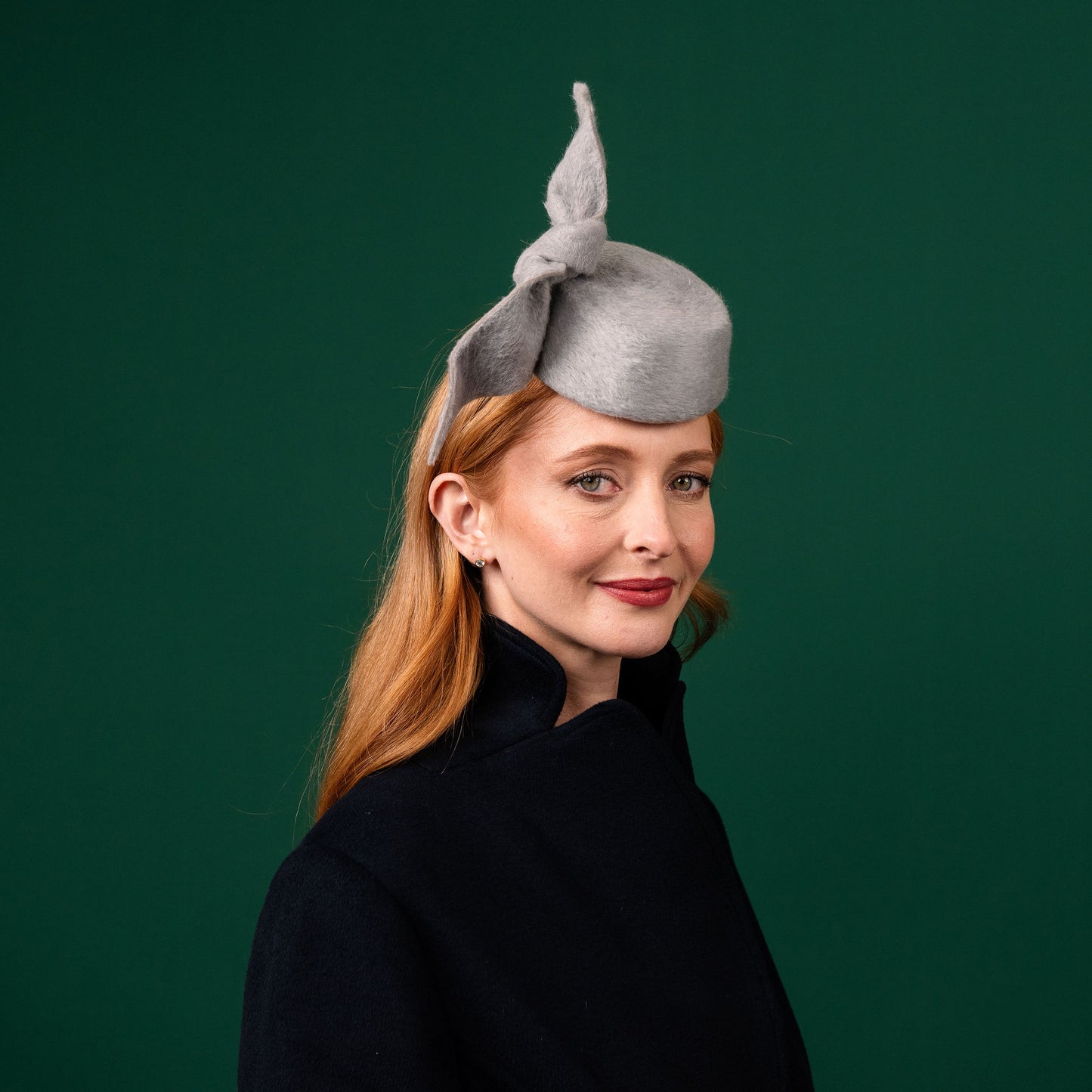Cresta mini grey felt front of head pillbox with a felt knot trim Winter Racewear Headpiece