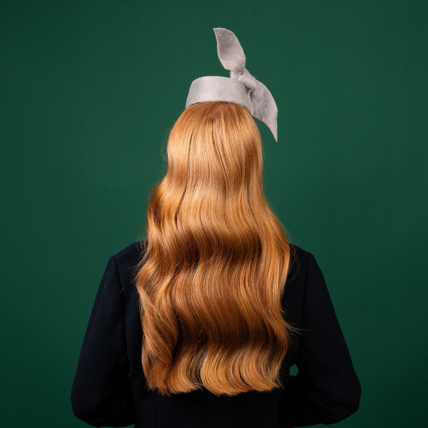 Cresta mini grey felt front of head pillbox with a felt knot trim Winter Racewear Headpiece