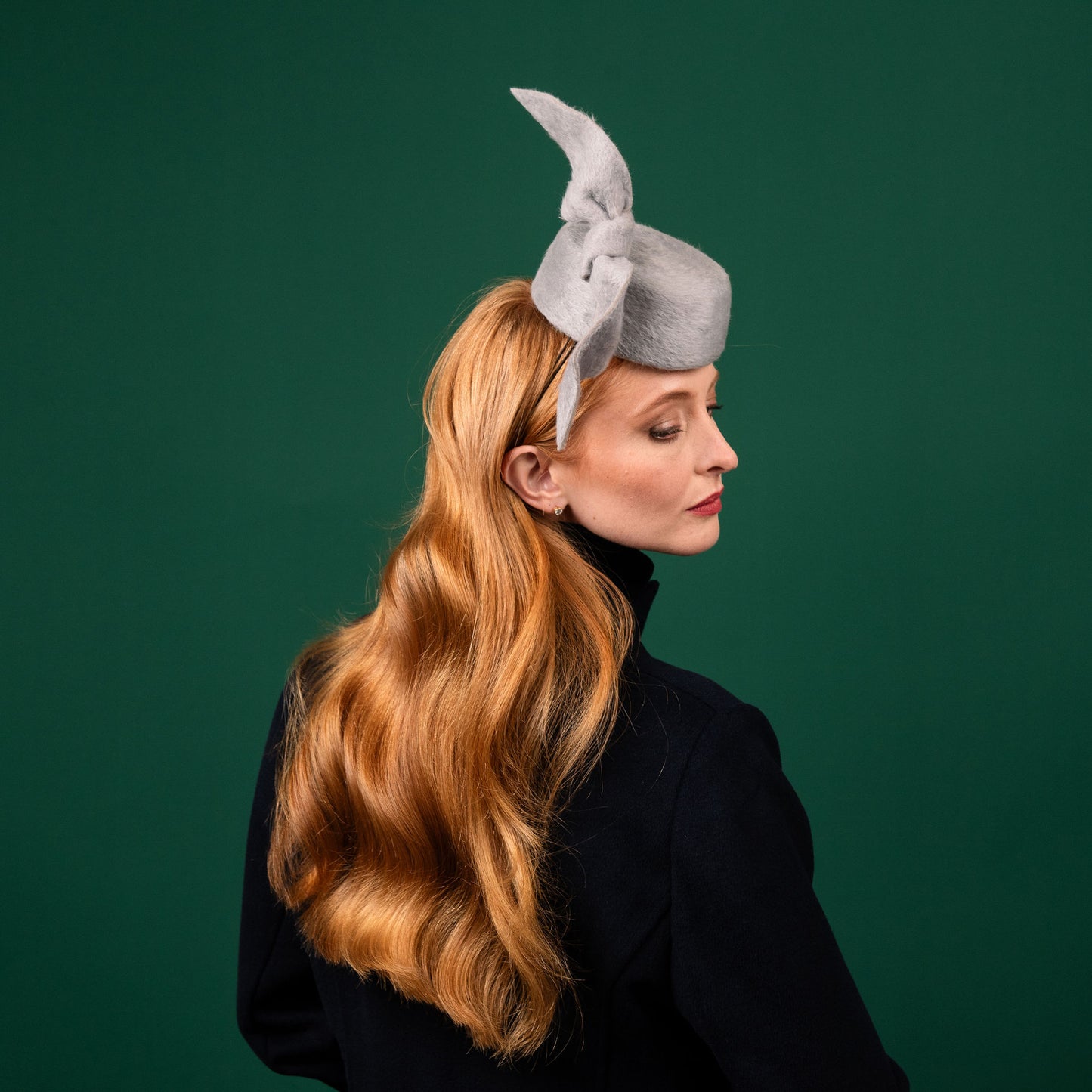 Cresta mini grey felt front of head pillbox with a felt knot trim Winter Racewear Headpiece