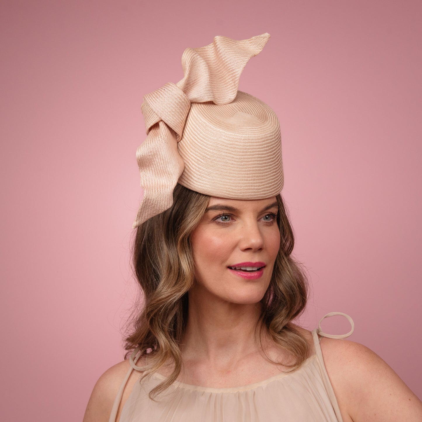Cristina front of the head pillbox in pale pink with a knot trim Spring Racewear Headpiece