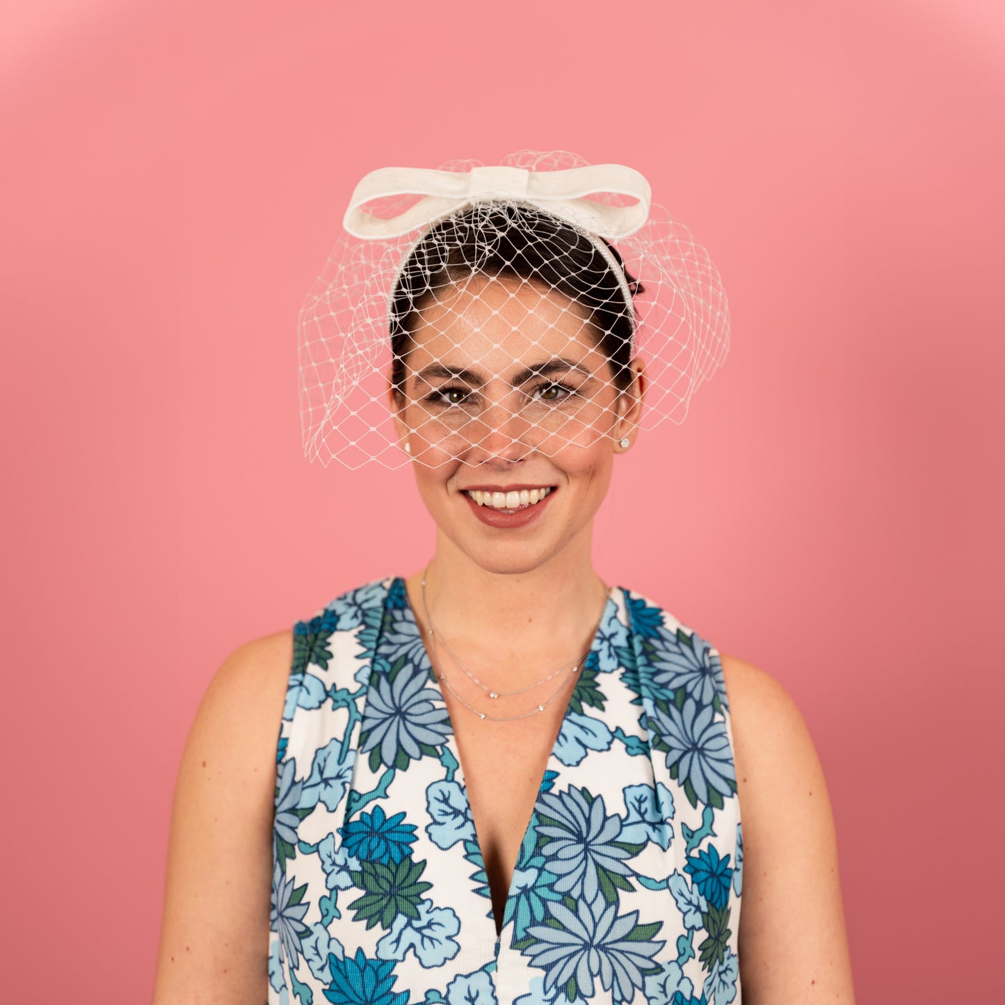 Abbey Headband with white birdcage veil with velvet bow in white