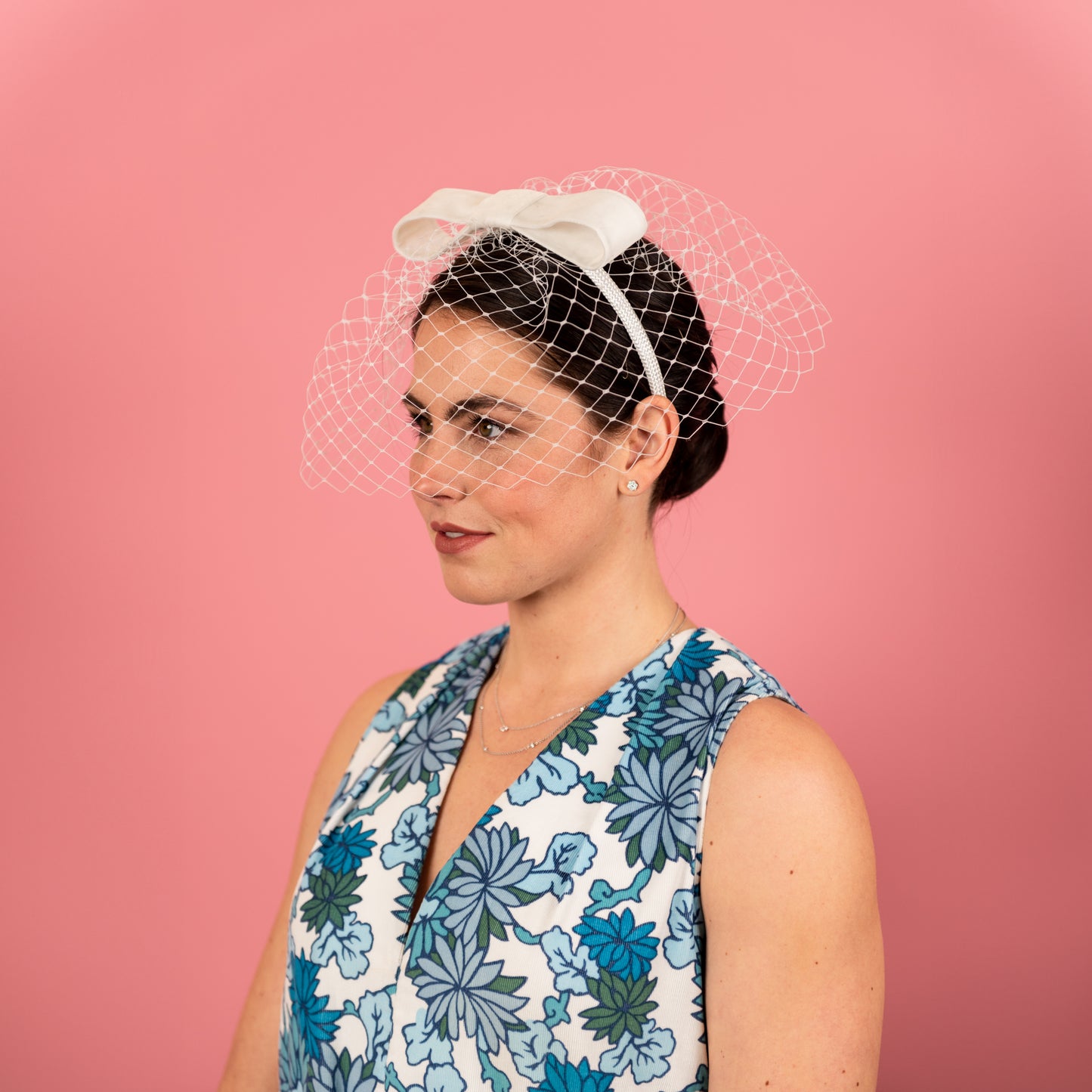 Abbey Headband with white birdcage veil with velvet bow in white