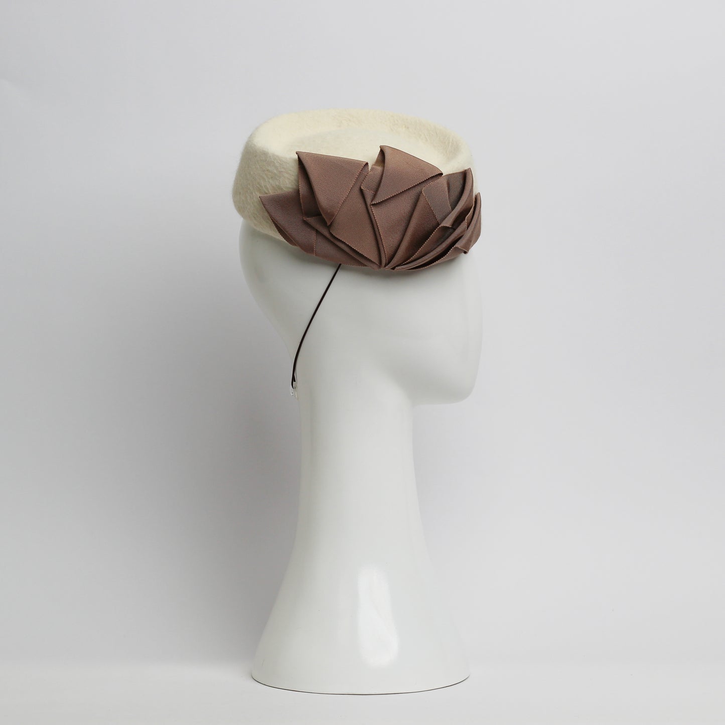 Fur felt Cream pillbox headpiece with pile trimmed taupe ribbon cockade by milliner Lauren J Ritchie