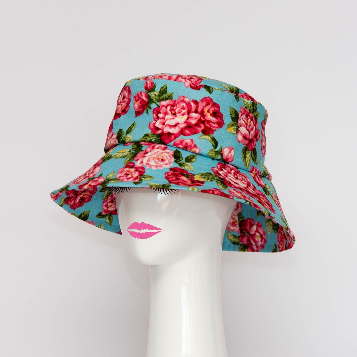 The Appin Bucket Hat in denim has a square shape crown with tip and side band. The angle of the hat in the photograph shows the flared brim which protects you from the sun. Created by Melbourne based Lauren J Ritchie Millinery.