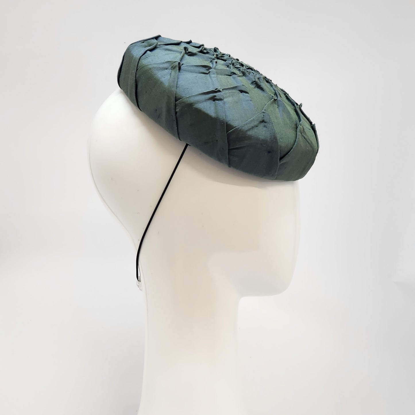Green pleated silk button beret