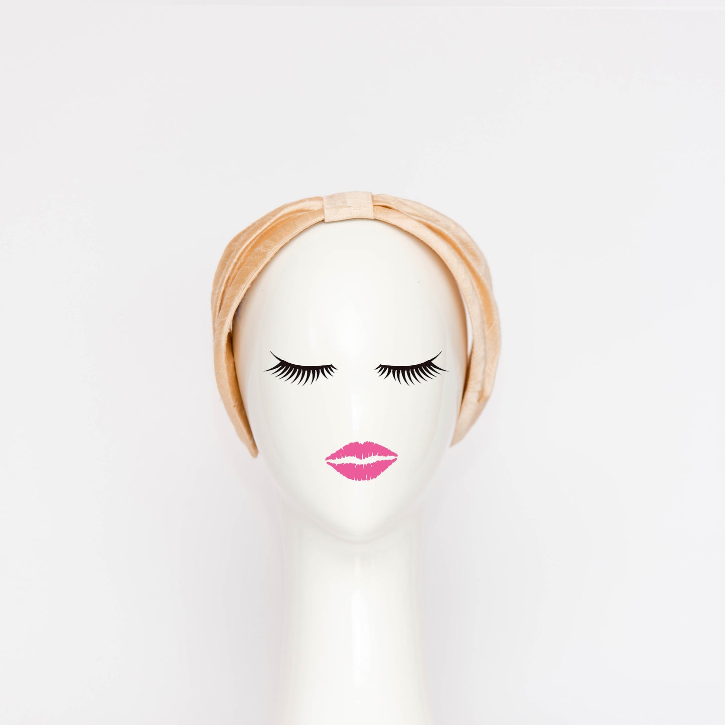 A front view of the Georgie Headband in black. The headband is a hand draped shape that is cinched with a centre wrap. The headpiece is created by Melbourne based Lauren J Ritchie Millinery.