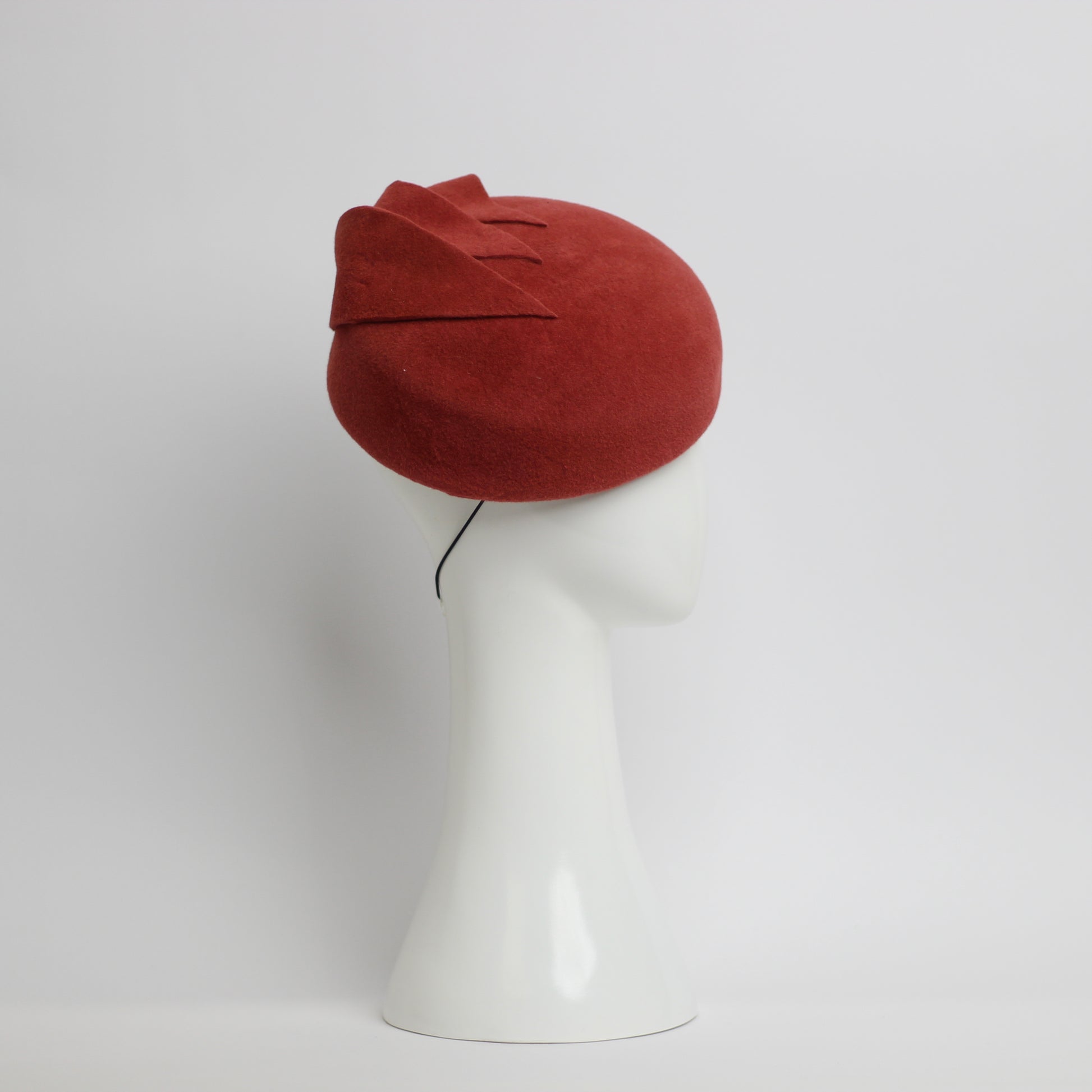 The sideview of a Rusty red coloured fur felt beret with cut felt leaf shape trim by milliner Lauren J Ritchie 