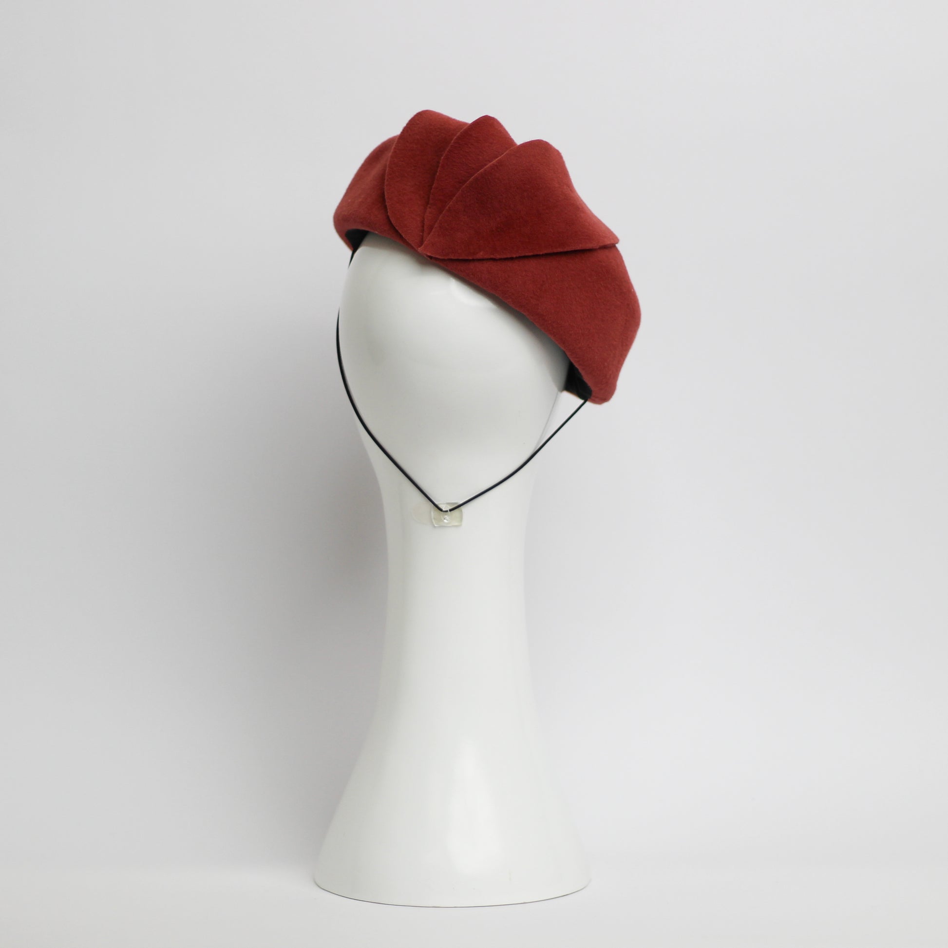 The back view of a Rusty red coloured fur felt beret with cut felt leaf shape trim by milliner Lauren J Ritchie 