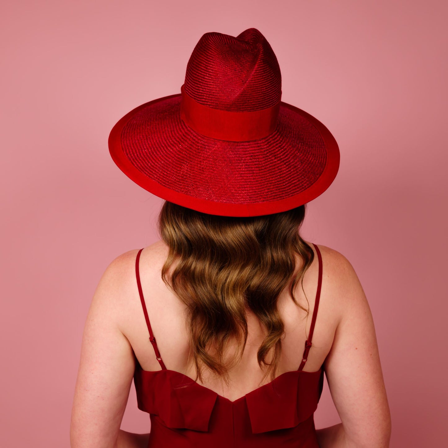 Charlotte wide brimmed hat with shaped crown in red straw and silver buckle