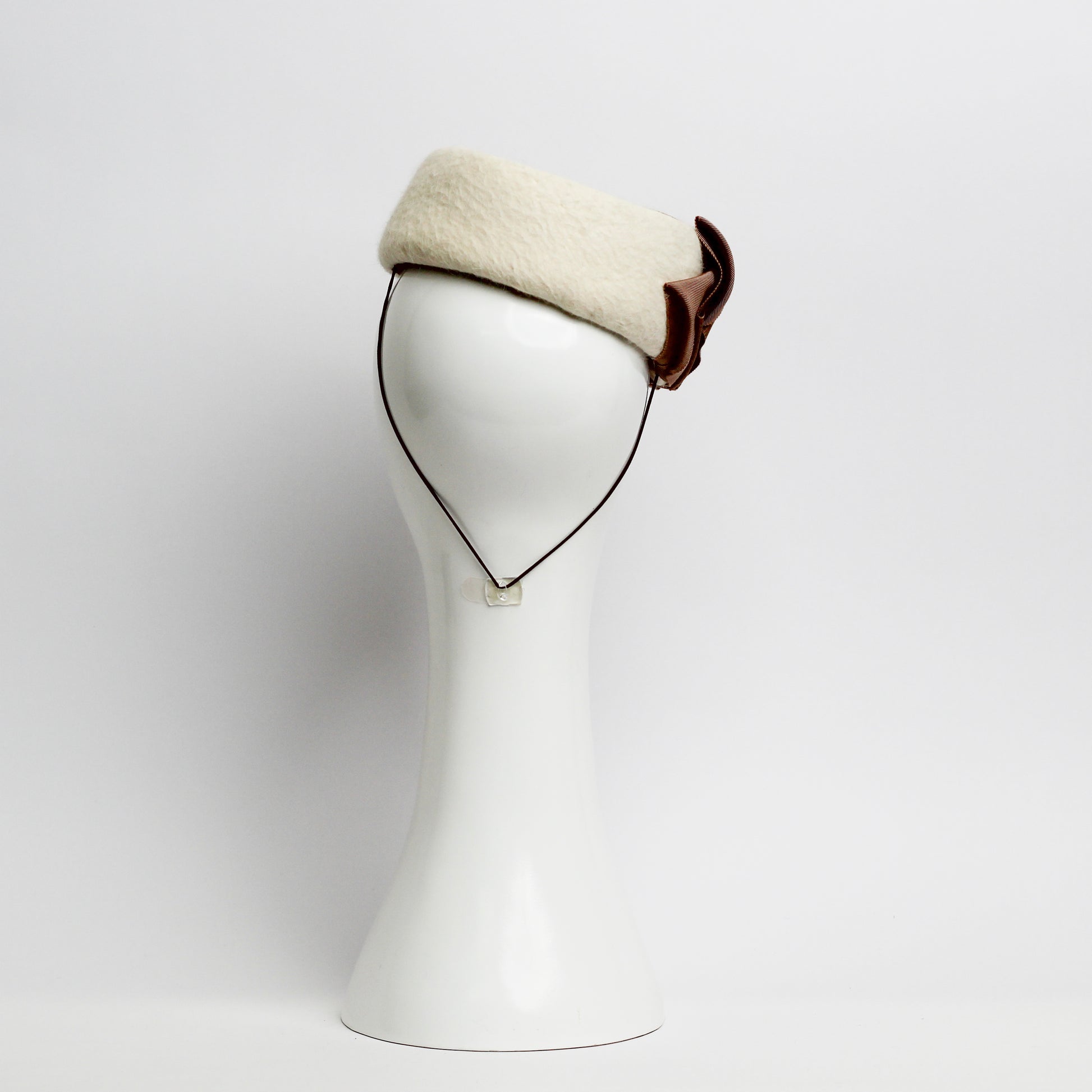 Fur felt Cream pillbox headpiece with pile trimmed taupe ribbon cockade by milliner Lauren J Ritchie 