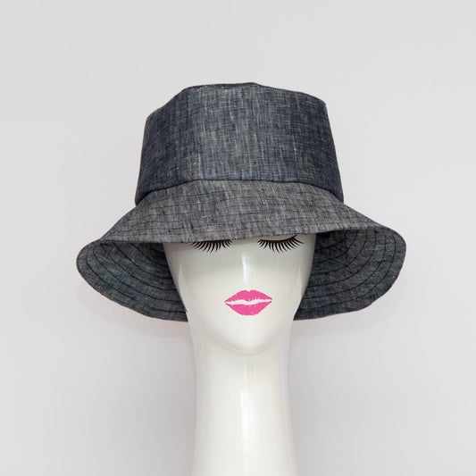 The Appin Bucket Hat in denim has a square shape crown with tip and side band.  The flared brim is 8cm wide to protect you from the sun.  Created by Melbourne based Lauren J Ritchie Millinery.