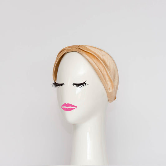 The Georgie Headband in cream. The headband is a hand draped shape that is cinched with a centre wrap.  The headpiece is created by Melbourne based Lauren J Ritchie Millinery.