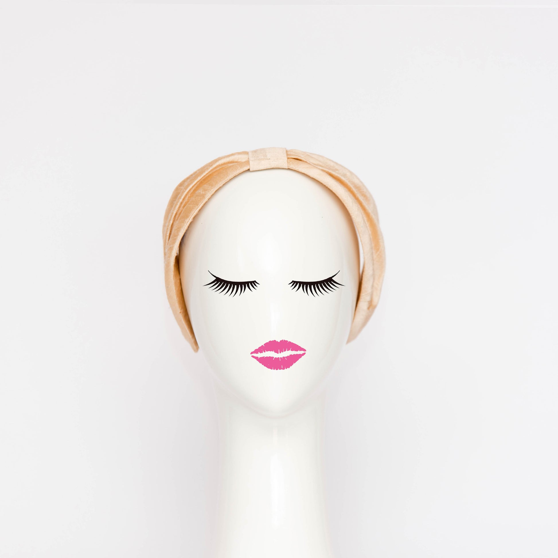 A front view of the Georgie Headband in black. The headband is a hand draped shape that is cinched with a centre wrap.  The headpiece is created by Melbourne based Lauren J Ritchie Millinery.